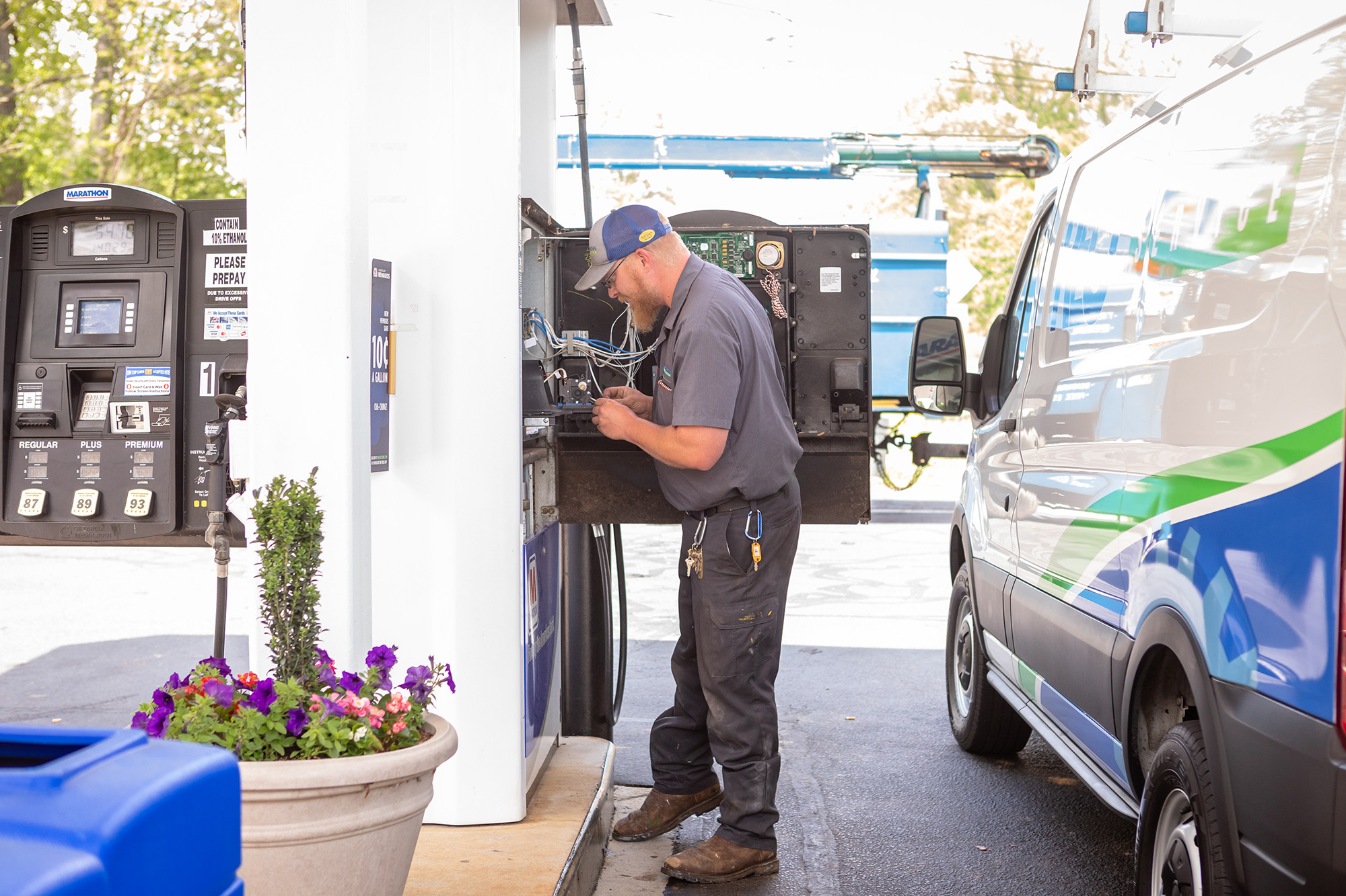 Gasoline, Diesel & Kerosene technician at a gas station pump.