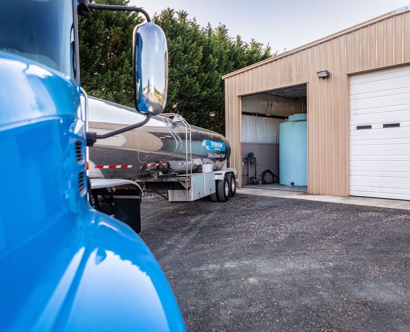 Close up photo of blue and silver diesel exhaust fluid delivery truck.