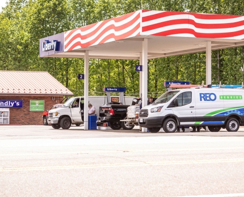 Liberty gasoline station with REO Service van parked at pump