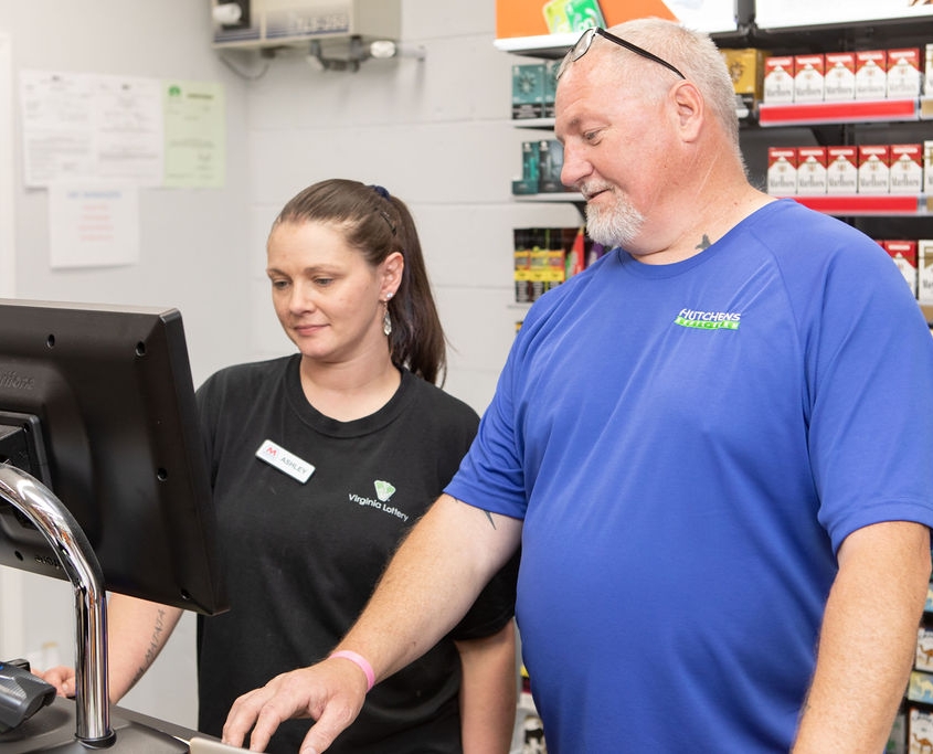 REO Service technician helping convenience store owner with C18 Verifone system