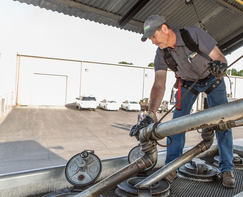 Hutchens Rentz-Eden employee filling a fuel truck from a storage tank getting ready for a fuel delivery.