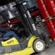 Hutchens forklift operator moving a pallet of red barrels