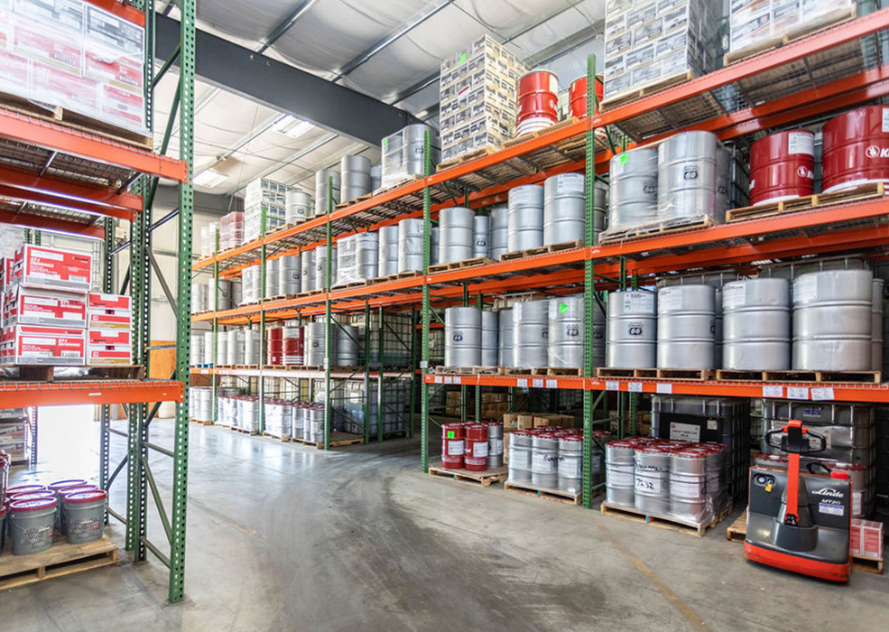 Warehouse with shelves of barrels containing API certified lubricants